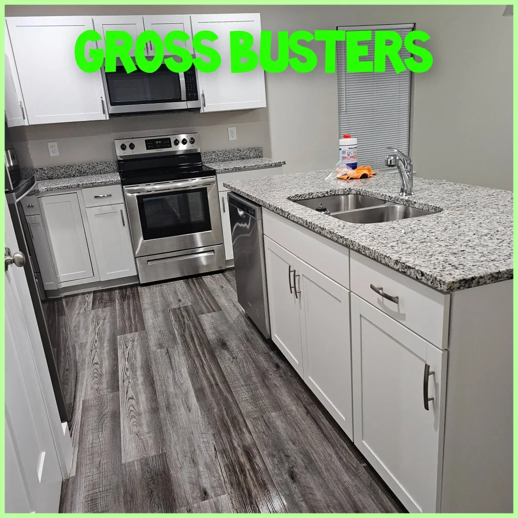 Clean modern kitchen with vinyl planks for flooring, white cabinetry, and quartz countertop island.